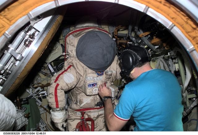NASA image: Dezhurov works on an Orlan suit in Pirs during Expedition Three