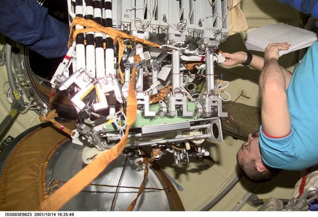 NASA image: Tyurin readies the NASDA exposure experiment cases for their EVA