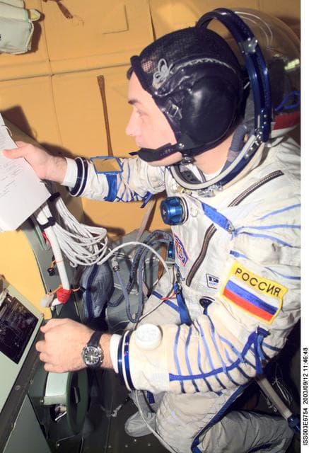 NASA image: Dezhurov follows procedures in the Soyuz spacecraft during Expedition Three
