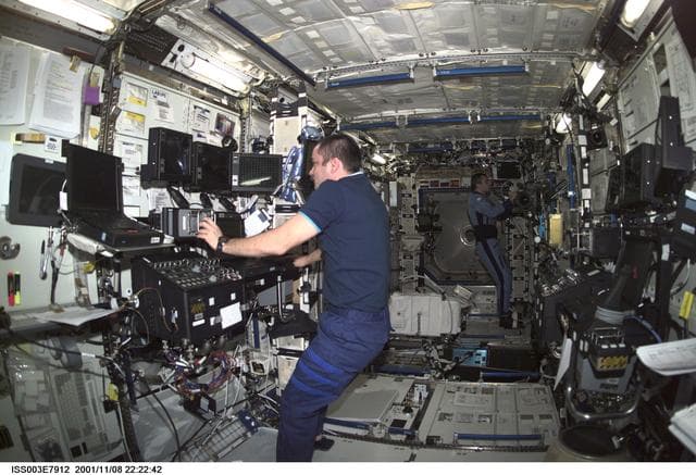 NASA image: Tyurin works at the SSRMS controls in Destiny during Expedition Three