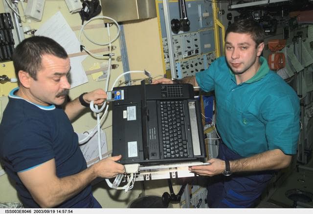 NASA image: Tyurin and Koveez handle the Plasmakristall Telescience Apparatus during Expedition Three