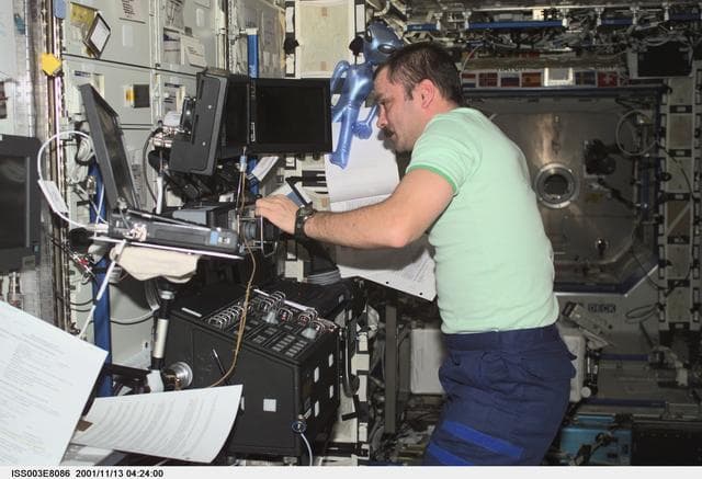 NASA image: Tyurin works at the SSRMS controls in Destiny during Expedition Three
