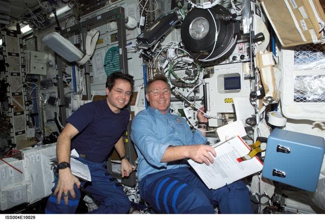NASA image: Bursch and Ross by EXPRESS rack 4 in the U.S. Lab during STS-110, Expedition Four joint OPS