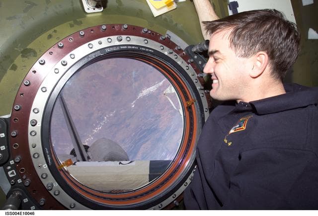 NASA image: STS-110 MS Walheim at nadir window in U.S. Lab during Expedition Four