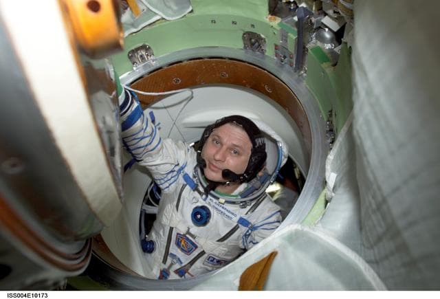 NASA image: Onufrienko enters the Soyuz 3 capsule during Expedition Four rescue craft relocation