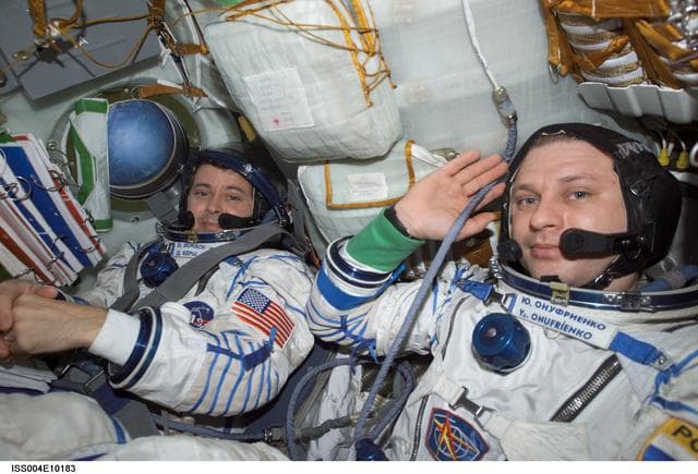 NASA image: Onufrienko and Bursch seated in the Soyuz 3 capsule during Expedition Four rescue craft relocation