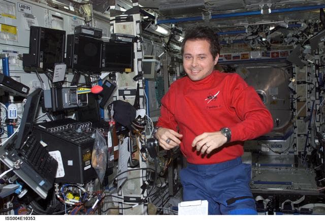 NASA image: Bursch poses beside the U.S. Lab RWS SSRMS controls during Expedition Four
