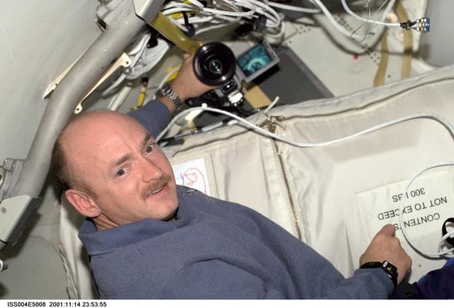 NASA image: Mark Kelly poses for the camera in the ISS during STS-108, Expedition Four