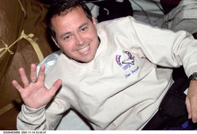NASA image: Dan Bursch smiles and waves for the camera from the middeck during Expedition Four