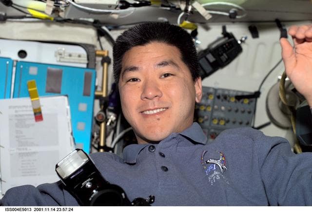 NASA image: Dan Tani smiles for the camera from Endeavour's middeck during STS-108, Expedition Four