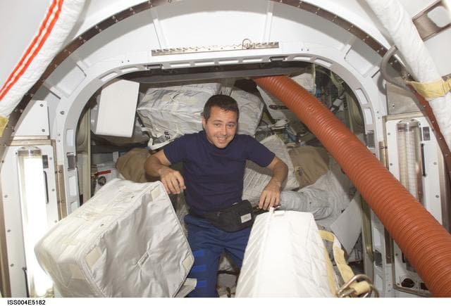 NASA image: Bursch in the Quest Airlock during Expedition Four unpacking and stowage OPS