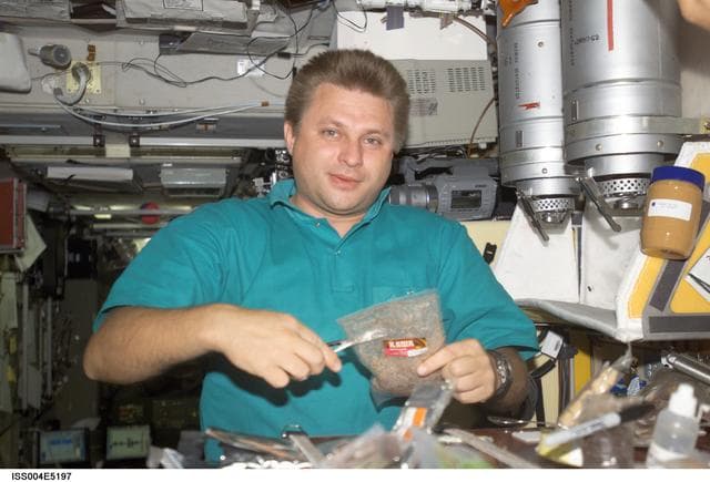 NASA image: Onufrienko prepares a meal in the SM during Expedition Four