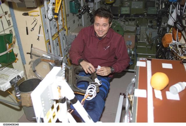 NASA image: Bursch configures equipment in the SM for EVA 2 during Expedition Four