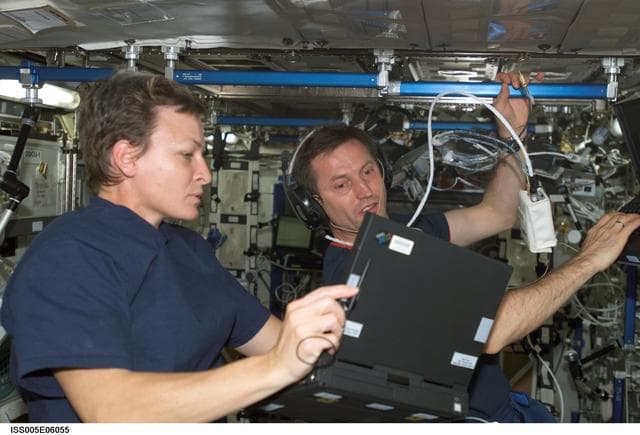 NASA image: Expedition Five Flight Engineer Whitson and Treschev during on-orbit hearing assessment