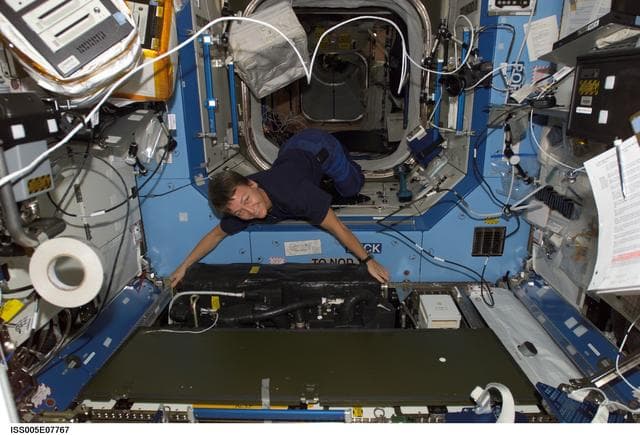 NASA image: Whitson moves equipment in the U.S. Laboratory during Expedition Five on the ISS