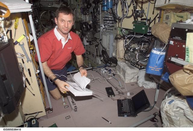 NASA image: Treschev thumbs through manual in the SM taken during Expedition Five on the ISS