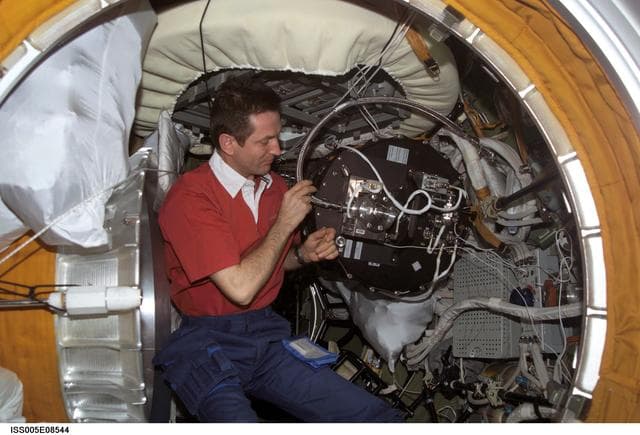 NASA image: Treschev disassembles the Plasmakristall Telescience Apparatus in the SM during Expedition Five