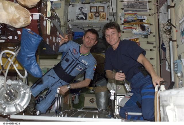 NASA image: Whitson and Treschev work on TVIS treadmill