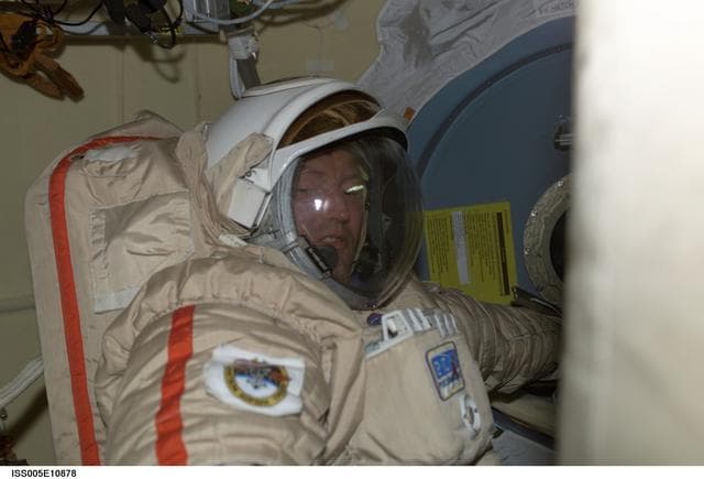 NASA image: Treschev attired in his Russian EVA Orlan suit prepares for an EVA in the Pirs Docking Compartment