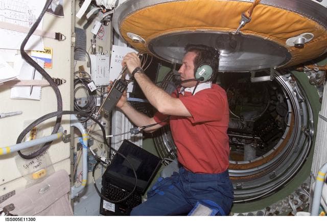 NASA image: Treschev uses an amateur radio in the FGB during Expedition Five on the ISS