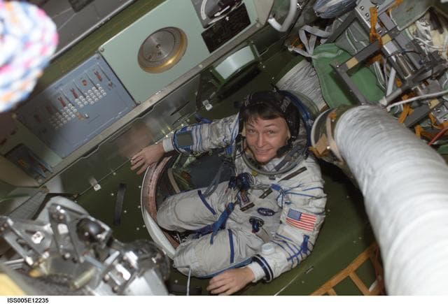 NASA image: Whitson moves through hatch in the Soyuz Spacecraft during Expedition Five on the ISS