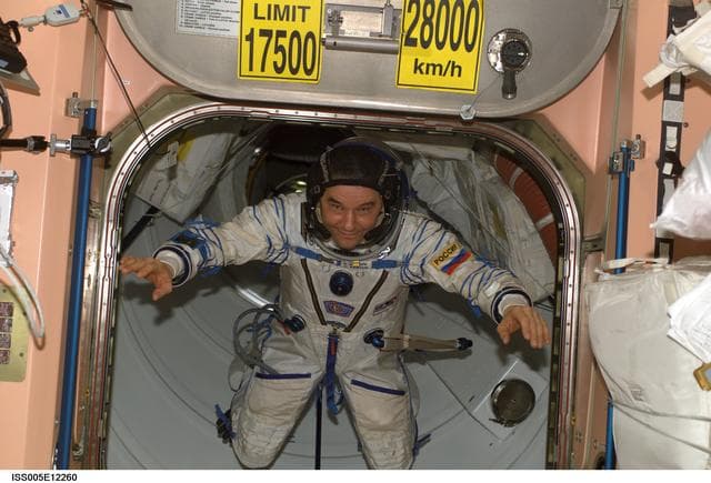 NASA image: Korzun moves through Node 1 hatch wearing his Russian Sokol suit during Expedition Five