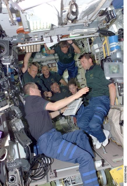 NASA image: Korzun and STS-112 crewmembers in the SM during Expedition Five on the ISS