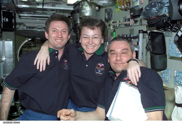 NASA image: Expedition Five crewmembers pose in the SM during Expedition Five on the ISS