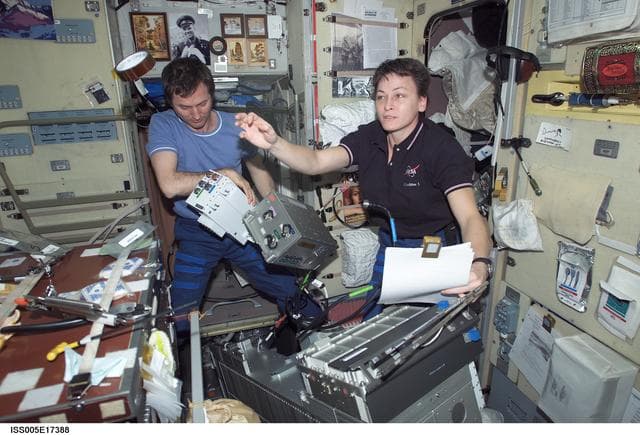 NASA image: Whitson and Treschev perform maintenance on the TVIS