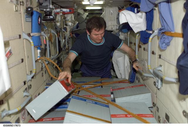 NASA image: Treschev checks stowage boxes in FGB/Zarya module