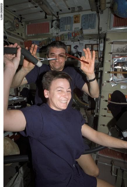 NASA image: Whitson receives haircut from Korzun in Zvezda