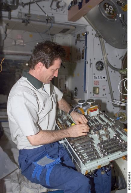NASA image: Treschev holds a pallet of tools in the Node 1 during Expedition Five on the ISS