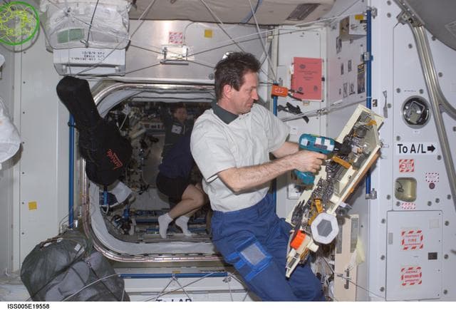 NASA image: Treschev holds a pallet of tools in the Node 1 during Expedition Five on the ISS
