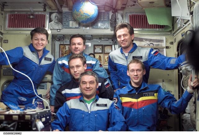 NASA image: Soyuz Five and Expedition Five crew pose in the SM during Expedition Five on the ISS