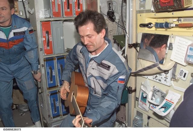 NASA image: Treschev plays guitar in the SM during Expedition Five on the ISS