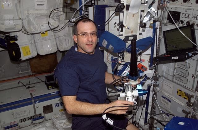 NASA image: Expedition Six Flight Engineer Donald R. Pettit is loading software on PC in U.S. Lab