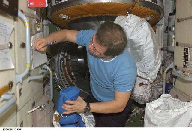 NASA image: Budarin takes inventory of medical equipment on the FGB during Expedition Six