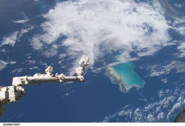 NASA image: View of the extended SSRMS or Canadarm2 with cloudy view in the background
