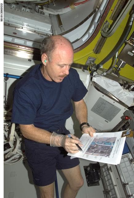 NASA image: Bowersox looks over O2 / N2 system paperwork in the Airlock during Expedition Six