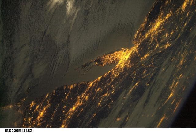 NASA image: Crew Earth Observations (CEO) of the Aurora Borealis and city lights taken during Expedition Six