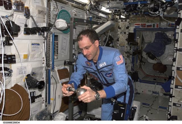 NASA image: Pettit uses a Grab Sample Container in the U.S. Laboratory during Expedition Six