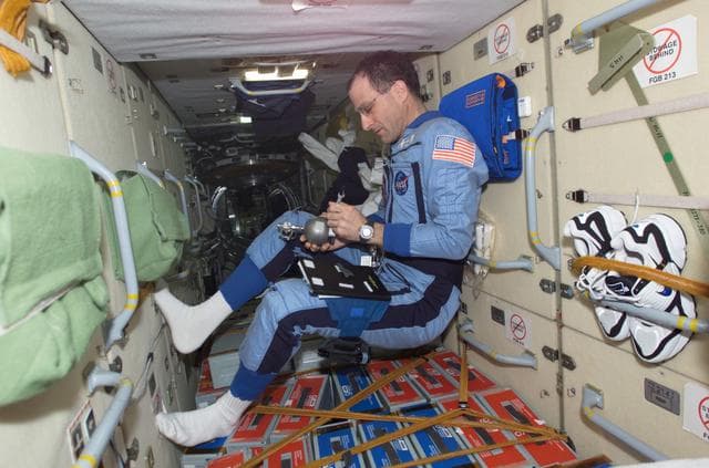 NASA image: Pettit uses a Grab Sample Container in the FGB during Expedition Six