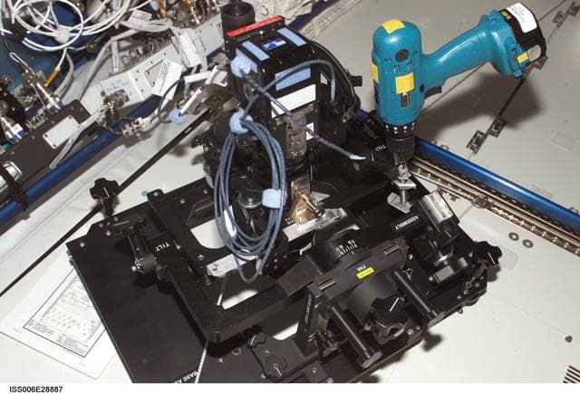 NASA image: View of a "barn door tracker" mounted on a camera in the U.S. Laboratory during Expedition Six