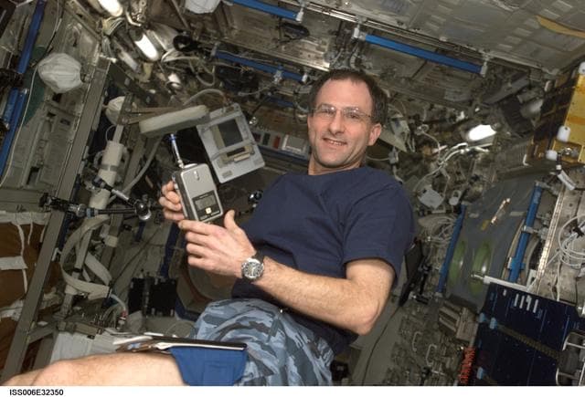 NASA image: Flight Engineer Donald R. Pettit holds a CPU440 as he poses in the U.S. Laboratory