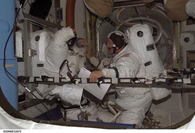 NASA image: Bowersox and Pettit are wearing EMU's in the Quest Airlock during Expedition Six