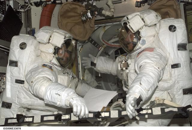 NASA image: Bowersox and Pettit are wearing EMU's in the Quest Airlock during Expedition Six
