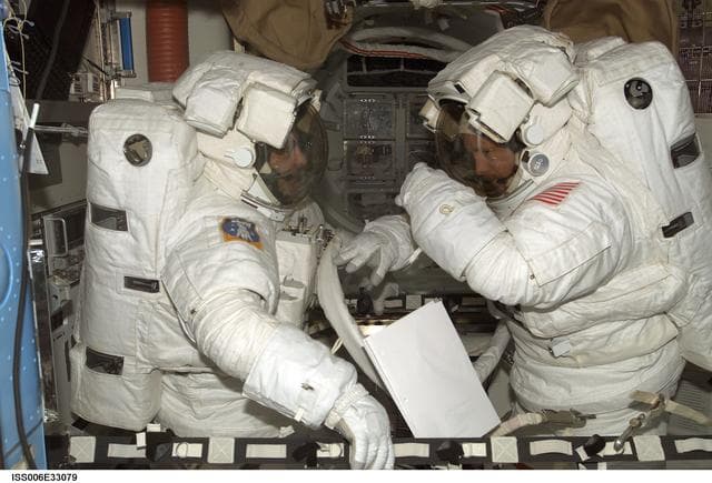 NASA image: Bowersox and Pettit are wearing EMU's in the Quest Airlock during Expedition Six
