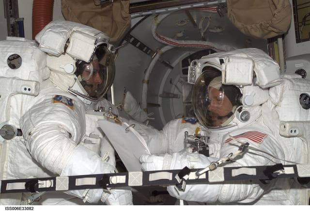NASA image: Bowersox and Pettit are wearing EMU's in the Quest Airlock during Expedition Six