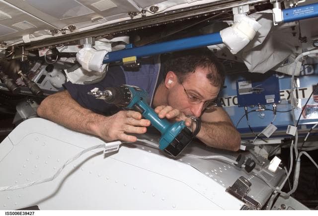 NASA image: Flight Engineer Donald R. Pettit is disassembling framework of the ITCS