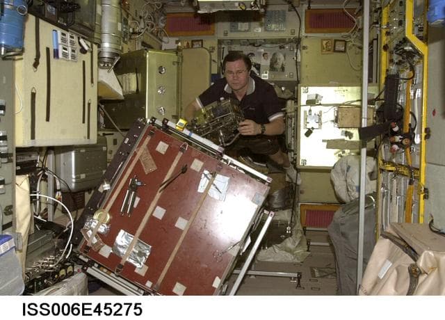 NASA image: Flight Engineer Budarin is changing a part in the water recycling system in the SM